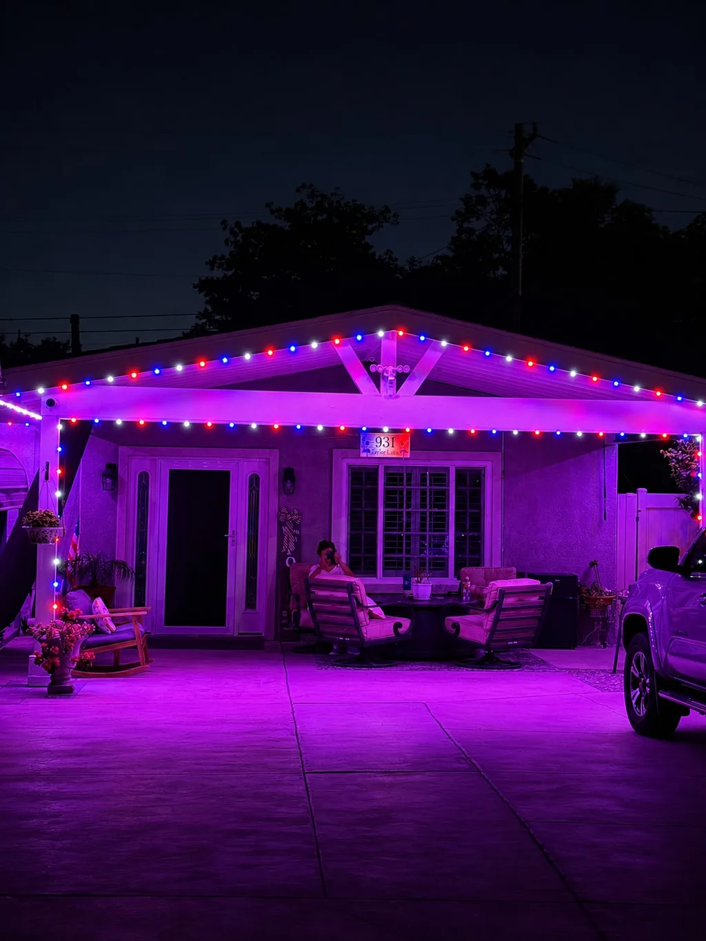 Rendering of a covered patio at night bathed in magenta light under a multicolor roofline